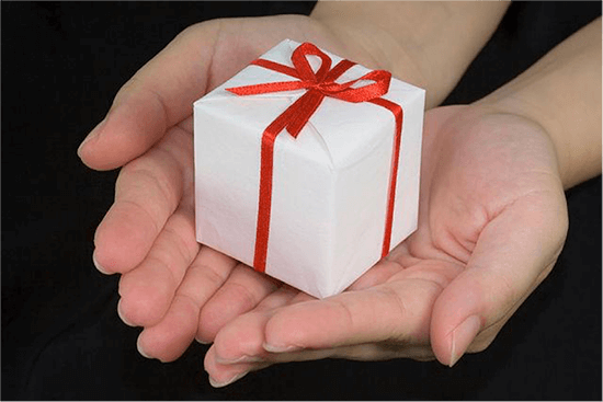 Wrapped gift in hands